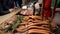 Cooking kebab,meat, sausages and steak on grill,on an open fire in evening at traditional street food festival