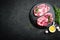 Cooking on kitchen table fresh raw pork marbled steaks on black background