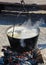Cooking large pot over the fire outdoors