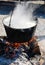 Cooking large pot over the fire outdoors