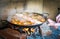 Cooking and making a traditional Spanish Paella over open fire w