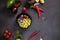 Cooking mango salsa - sliced chopped ingredients in a black ceramic bowl