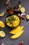 Cooking mango salsa - sliced chopped ingredients in a black ceramic bowl