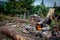 Cooking meal in a kettle on burning campfire in wild camping