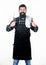 Cooking meat in park. Barbecue master. Bearded hipster wear apron for barbecue. Roasting and grilling food. Man hold