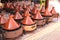 Cooking of meat in traditional Moroccan ceramic tajine dish, Morocco