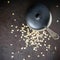 Cooking oatmeal in ceramic ware. Metal spoon and ceramic lid. View from above. Plenty of space for text or image