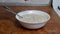 Cooking oatmeal, a woman pours sugar malt oatmeal, close up, breakfast