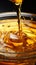 Cooking oil delicately cascades into a glass bowl in a captivating closeup