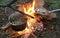 cooking on an open fire during bushcraft in the woods