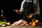 Cooking Peking Duck chef with fruit, on a black background. Horizontal photo, space for menu and design, restaurants, hotel