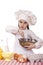 Cooking and people concept - smiling little girl in cook hat