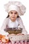 Cooking and people concept - smiling little girl in cook hat