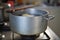 Cooking phase of dumplings in the boiling water set in aged silver aluminum pot on the gas cooker