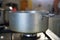 Cooking phase of dumplings in the boiling water set in aged silver aluminum pot on the gas cooker