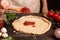 Cooking pizza. Hands adding fresh tomato sauce to pizza dough. Pizza ingredients on the wooden table