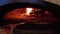 Cooking Pizza in an Italian Woodfired Clay Oven in a Restaurant