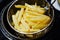 Cooking potato fries in a home mini fryer.