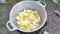 Cooking potatoes in a pot of boiling oil outdoors. Cooking fried potatoes in village slices.