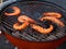 Cooking prawns on a barbecue.