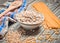 The cooking process. A bowl of raw oatmeal, cereals, pasta, wooden spoon and towel on a wooden table. Preparation of morning bre