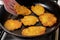 The cooking process in a pan of potato pancakes. Frying potato pancakes in vegetable oil.