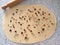 Cooking process. Preparing sugar roll, croissant, cake, buns or cookies. Rolled out yeast dough with dry cranberries and nuts.