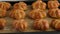 Cooking pumpkin buns. Ready pumpkin buns were taken out of the oven on baking sheet, close-up. Autumn concept. Breakfast