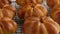 Cooking pumpkin buns. Ready pumpkin buns on a wire rack, close-up. Autumn concept. Breakfast buns. Fresh buns.