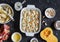 Cooking pumpkin, ricotta and spinach stuffed shells. On a dark background, top view.