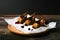 Cooking quail against a dark background. On a wooden background. low key. Little turkey