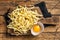 Cooking raw spaetzle egg noodle. Wooden background. Top view