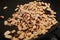 Cooking roasted ground peanuts on pan. Selective focus