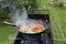 Cooking shakshuka in the pan on the grill