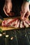 Cooking shish kebab from the underbelly on the kitchen table by the hands of a butcher. Adding spices to meat for aroma and taste