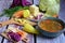 Cooking soup and slicing fresh vegetables on a rustic kitchen worktop, healthy eating concept. Closeup