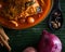 Cooking spices on banana leaf. Cardamom and star anise on a wooden spatula. Buah pelaga, bunga lawang, Selective focus