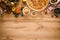 Cooking Thanksgiving autumn apple pie with fresh fruits and walnuts on wooden background