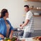 Cooking together is how we learnt what foods we love. a married couple making food together in the kitchen at home.