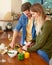 Cooking together makes everything more delicious. a smiling young couple standing at their kitchen counter chopping up