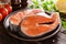 Cooking two fresh raw salmon fish steaks on wooden rustic table