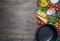 Cooking vegetarian pasta with cherry tomatoes, parsley, onion and garlic, butter, tomato paste cheese, on a rustic wooden back