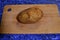 Cooking. The washed potato tuber lies on a wooden board.