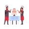 Cooks couple professional pastry chefs decorating tasty wedding cream cake woman man restaurant workers in uniform