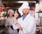 Cooks greeting customers at bistro