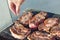 Cooks hand salt the meat in a barbecue