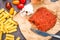 Cooks` ingredients for pasta with spicy nduja sausage with tomat