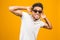 Cool afro american man wearing sunglasses over isolated background, having successful idea. Exited and happy. Number one