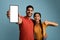 Cool App. Happy Arab Couple Demonstrating Blank Smartphone And Showing Thumb Up