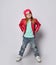 Cool blond baby girl kid in red leather jacket, white t-shirt and blue jeans, sunglasses and hat poses